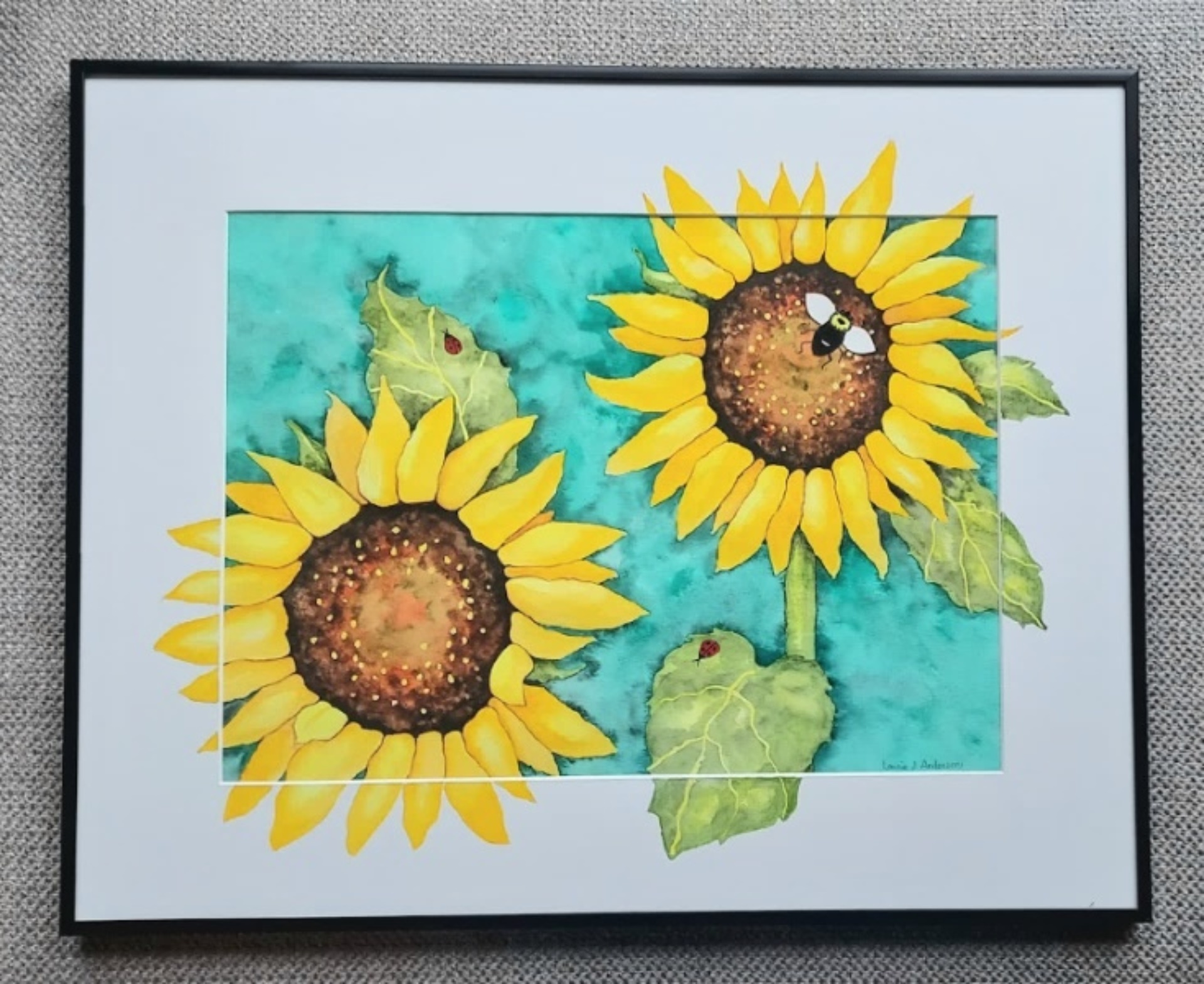 Painted sunflowers inside a frame.