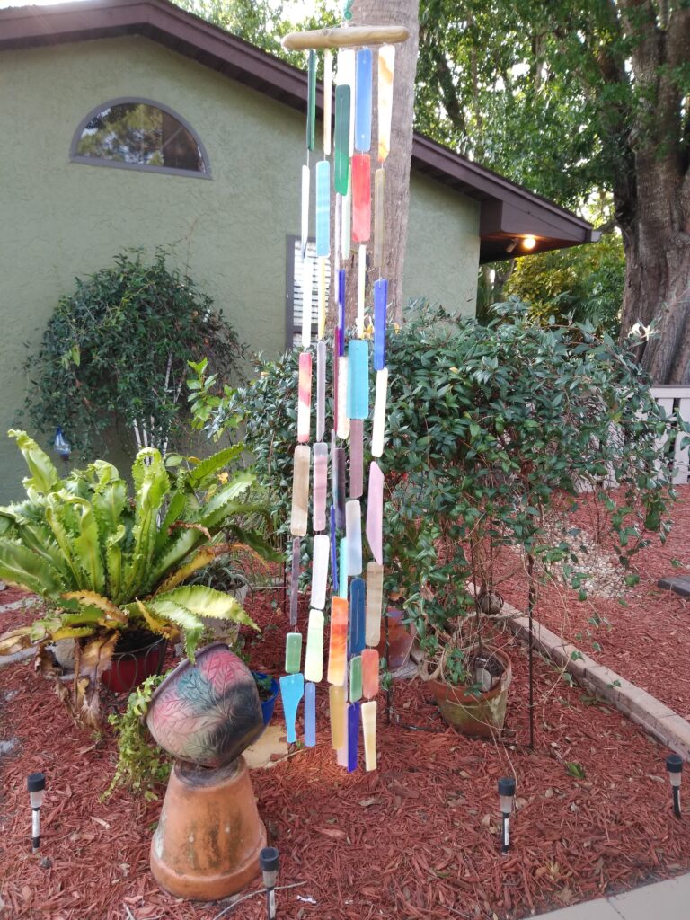 A handmade windchime made of stained glass.
