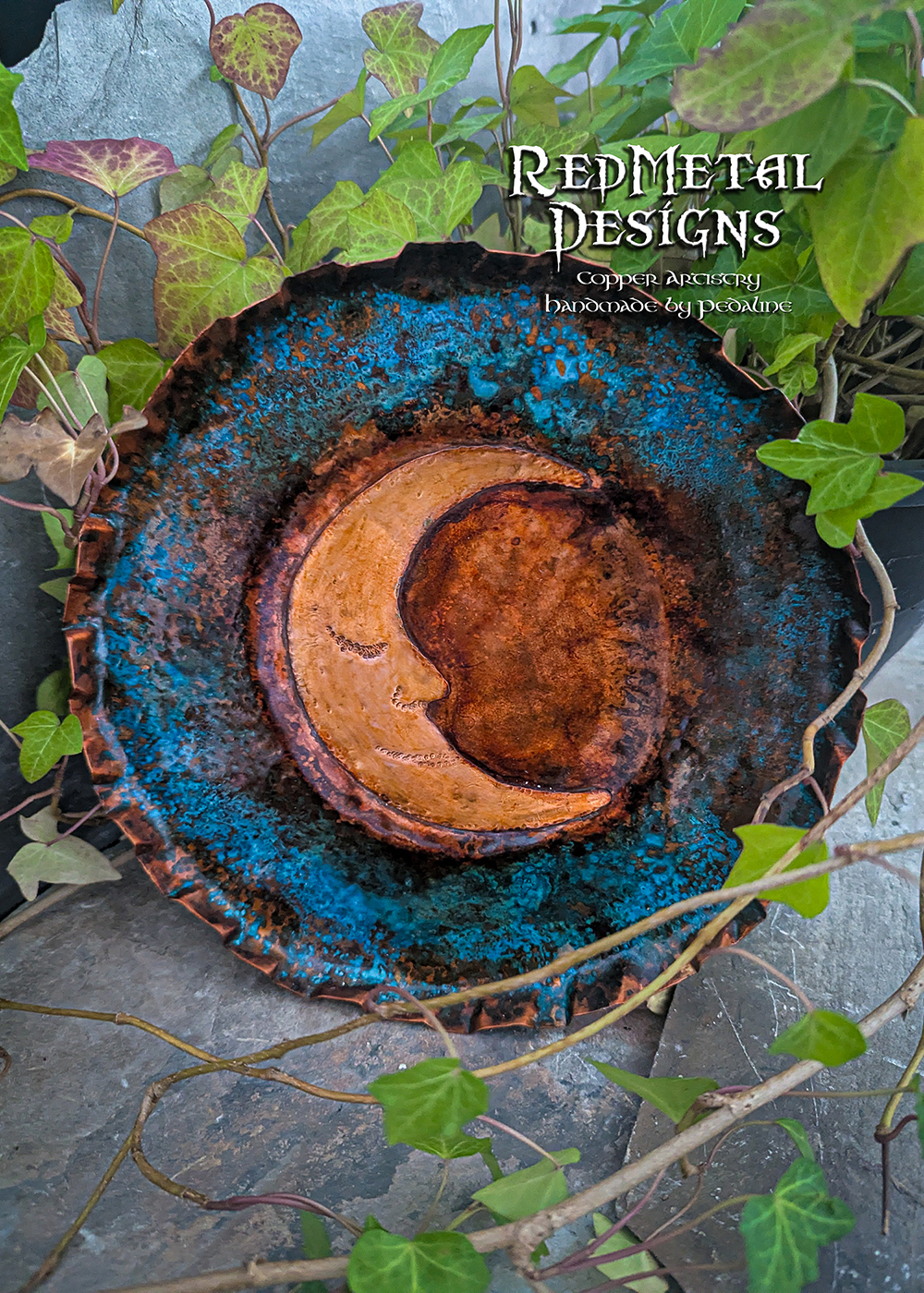 A metal dish with a crescent moon design in the center.