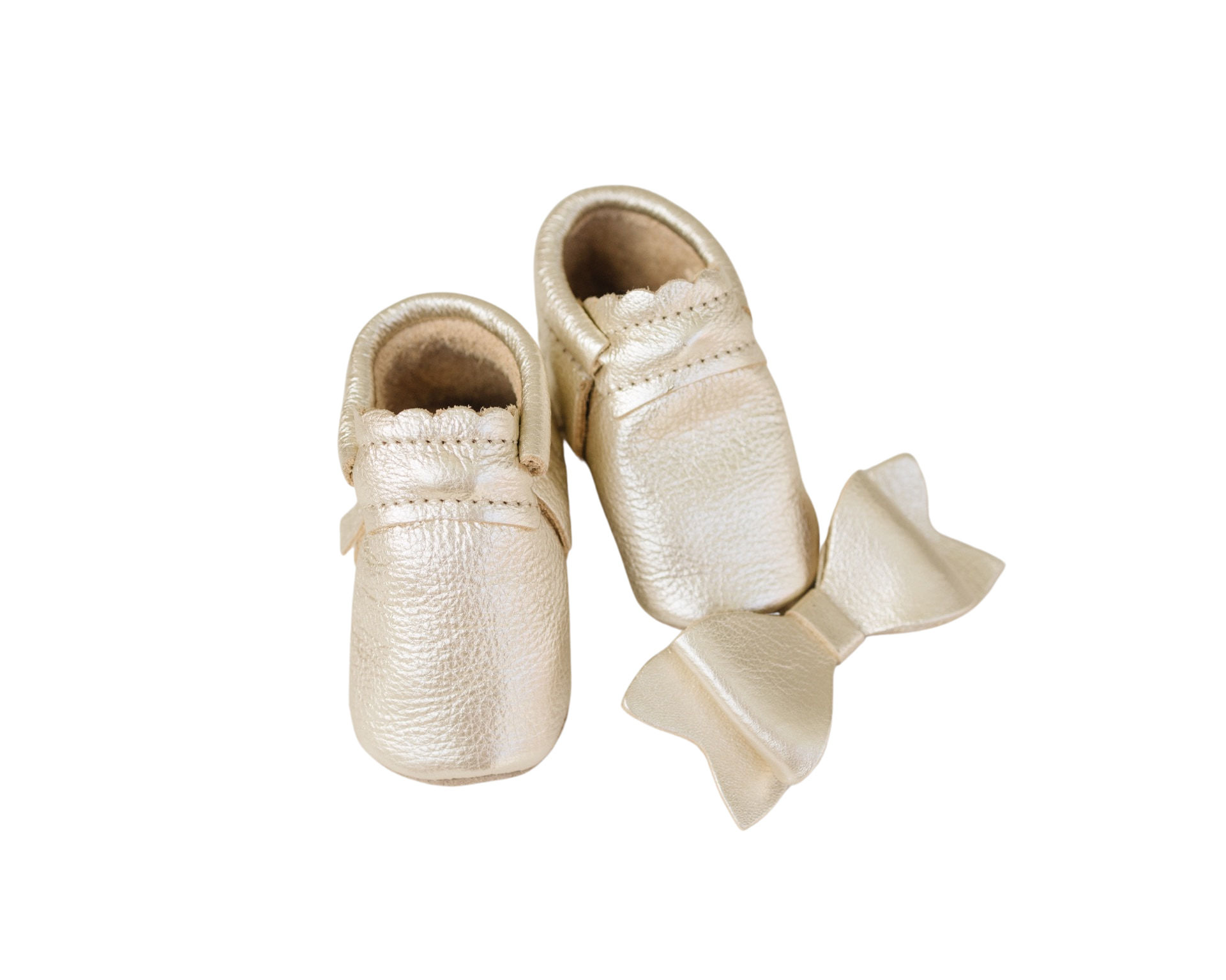 A pair of baby's shoes with a bow.