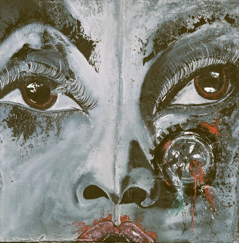 A painted face with abstract splatters overtop.