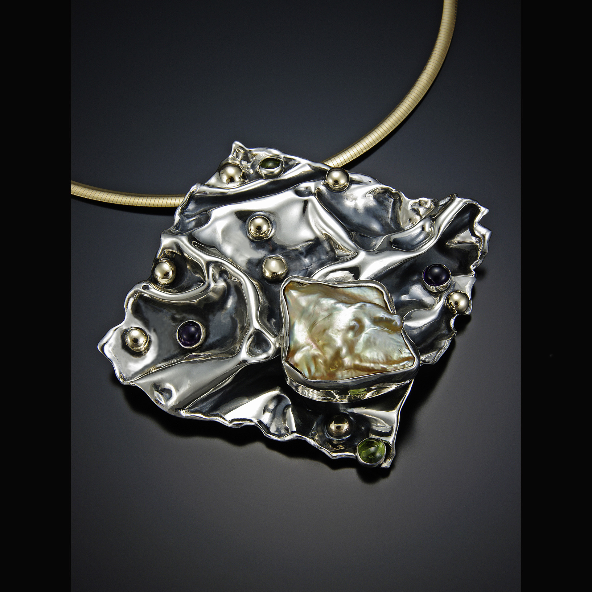 A hand-fabricated silver piece of jewelry.
