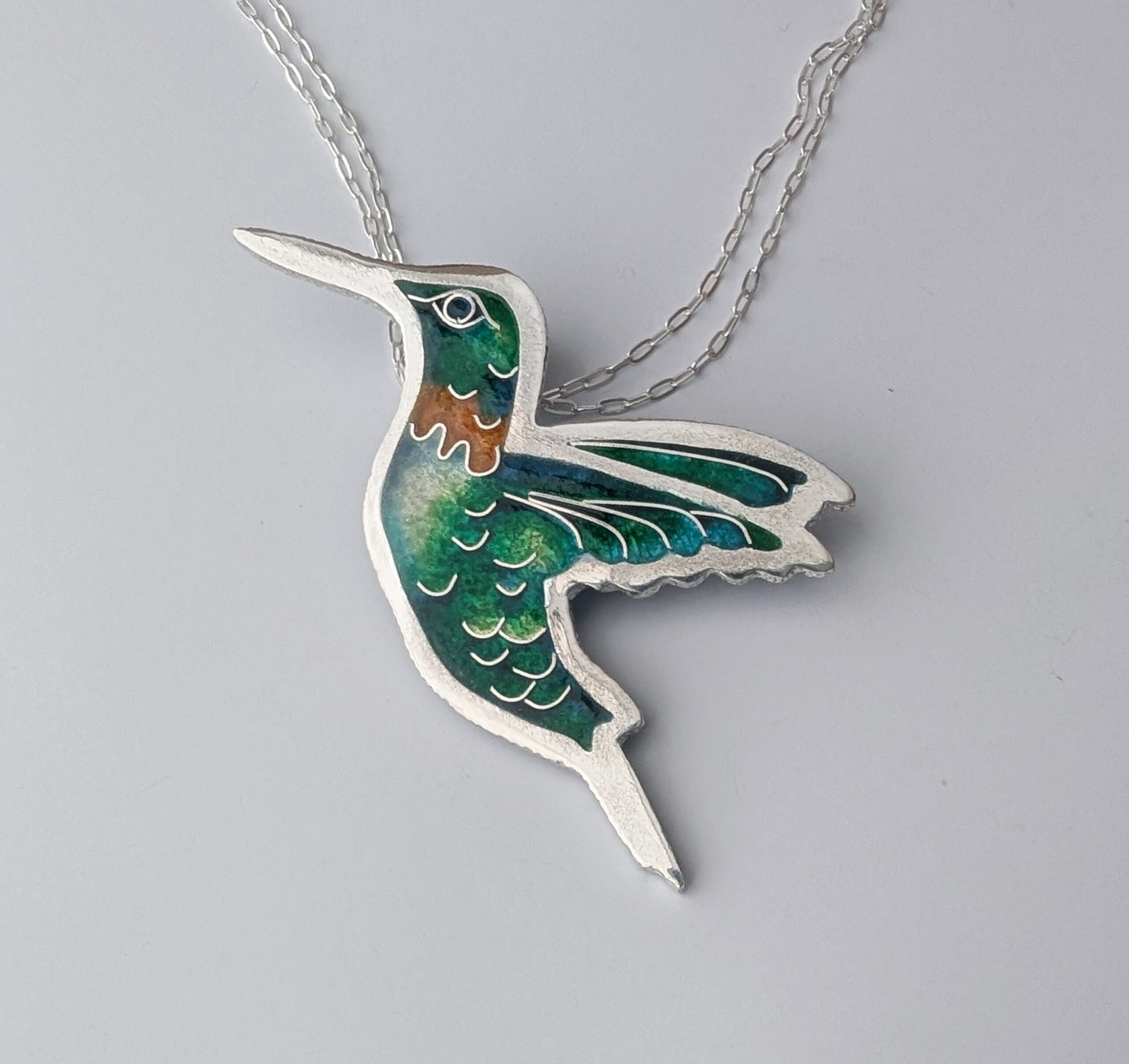 A handmade hummingbird pendant.
