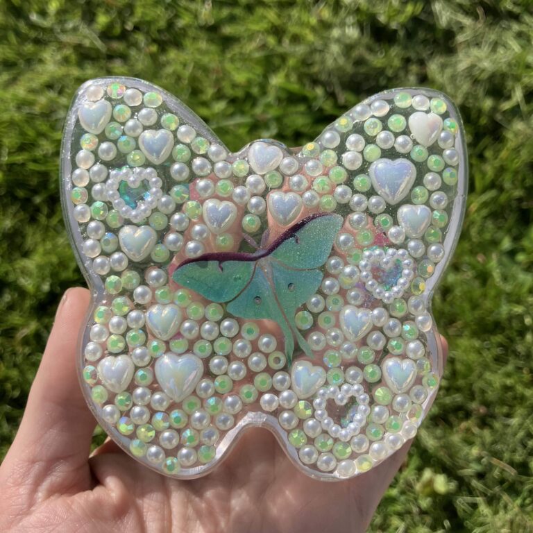 A butterfly-shaped piece of jewelry made of colorful beads.