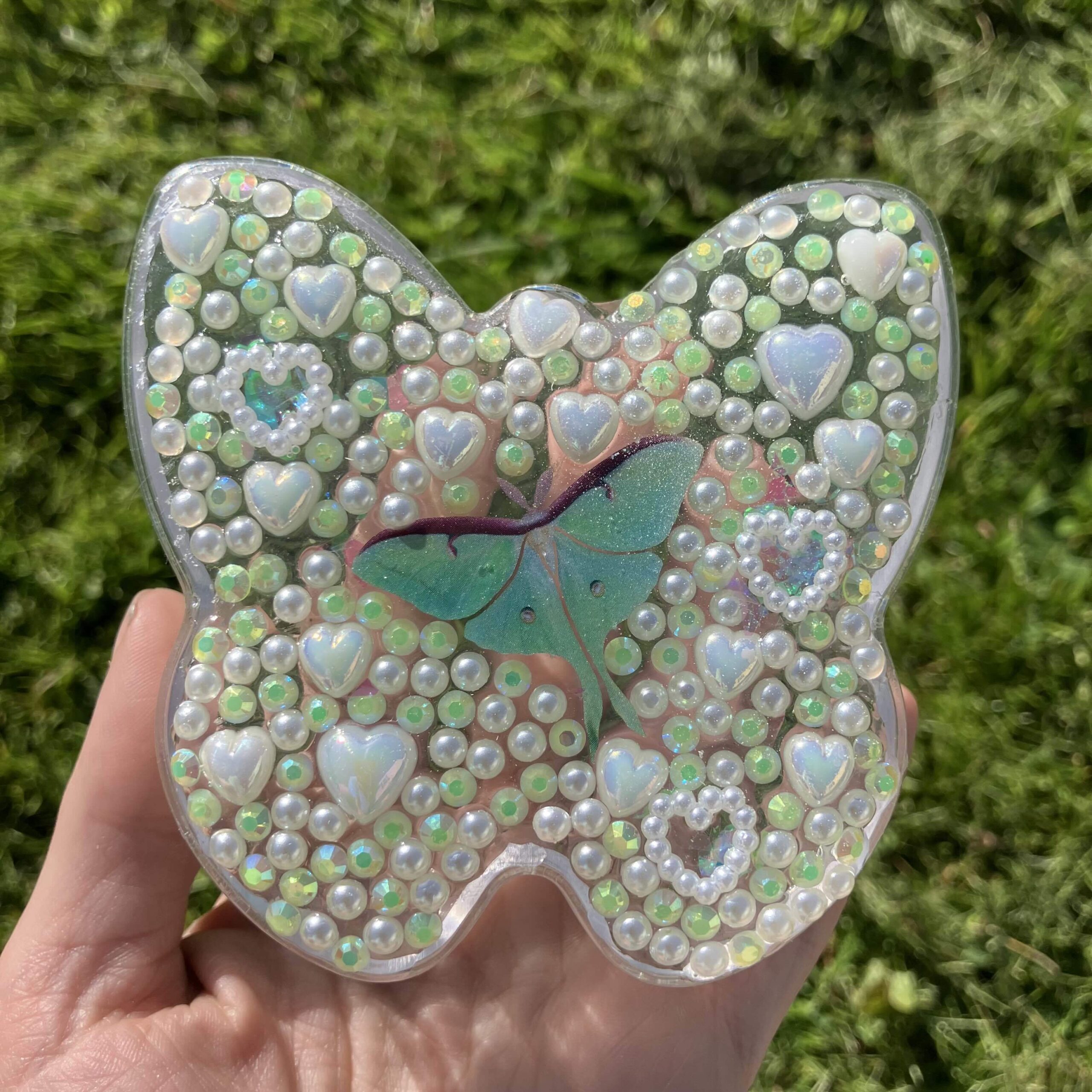 A butterfly-shaped piece of jewelry made of colorful beads.