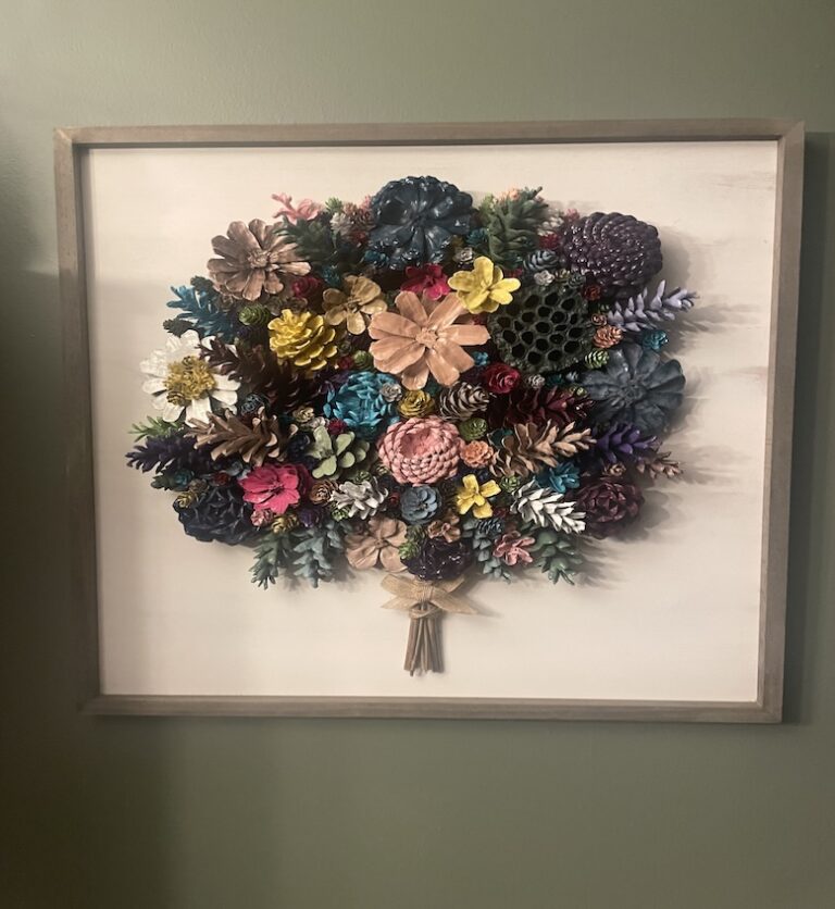 Artistic arrangement of multi-colored flowers within a frame.