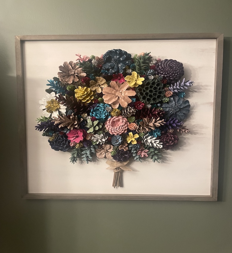 Artistic arrangement of multi-colored flowers within a frame.
